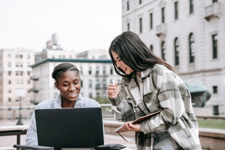 Students looking at a laptop.